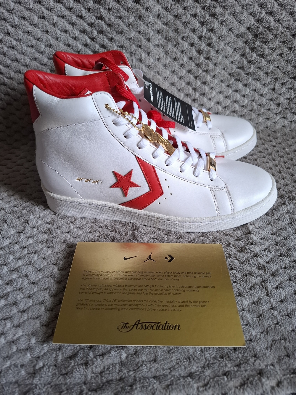 Converse “Champions Think 16” White & Red Leather High Tops